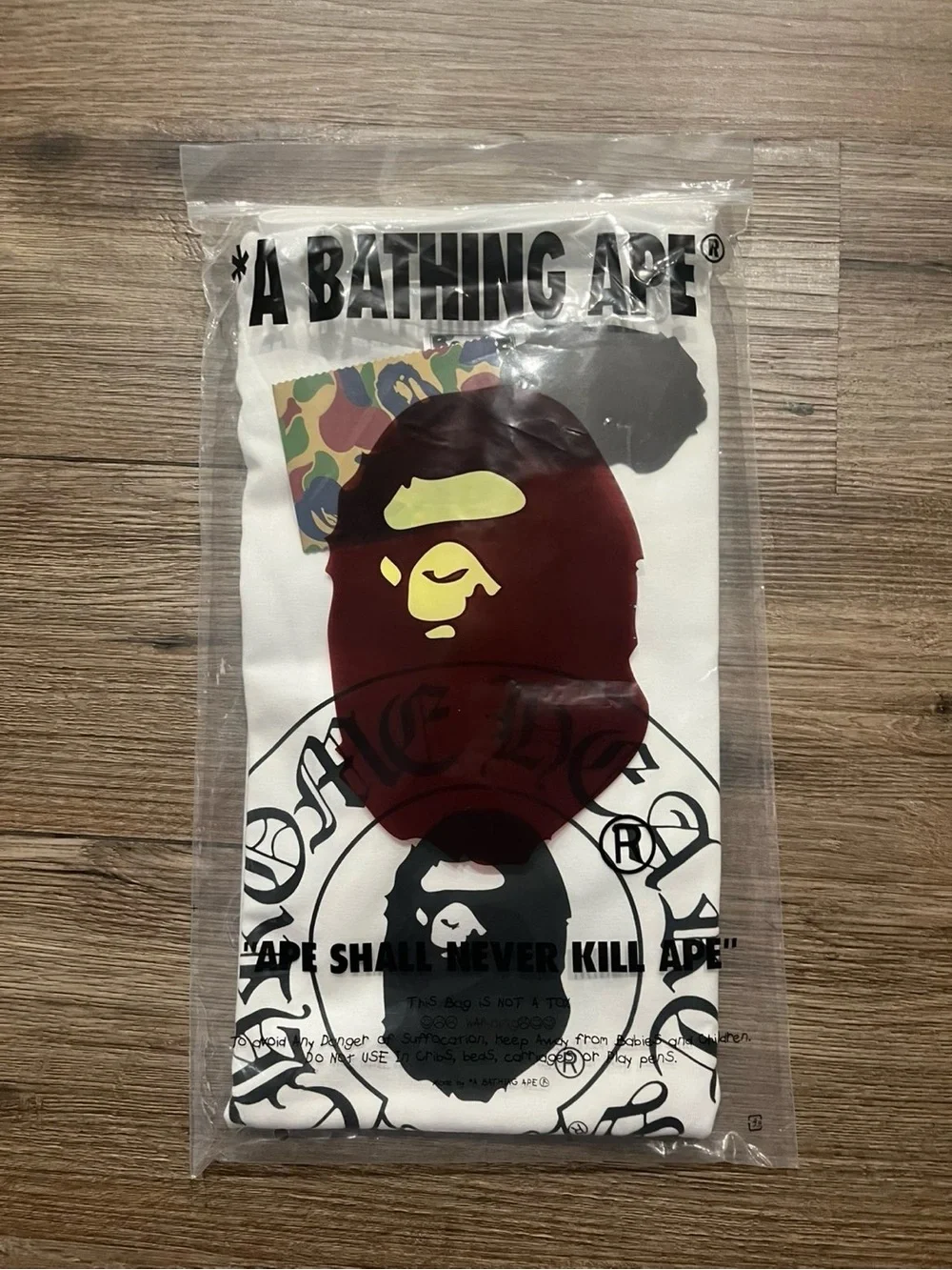 Bape Kids White Tee with Maroon Ape Head and Yellow Accent